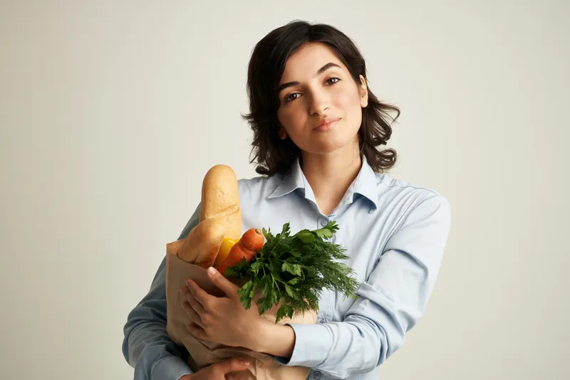 Брюнетка с продуктовым пакетом, доставка из супермаркета