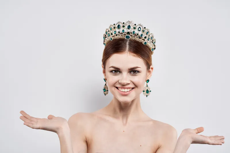 Красивая женщина в короне на голове, модель с макияжем, изолированный фон