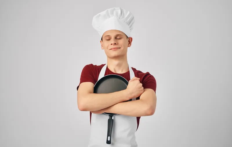 Мужчина в форме шеф-повара занимается приготовлением пищи