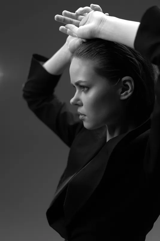 serious woman in black and white portrait showing thoughtful expression and elegance in studio lighting