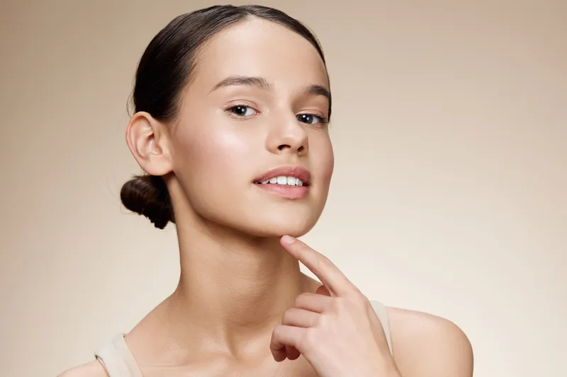 Portrait of a young woman with smooth skin, natural makeup, and a confident expression, showcasing skincare beauty and self care routines for a healthy lifestyle