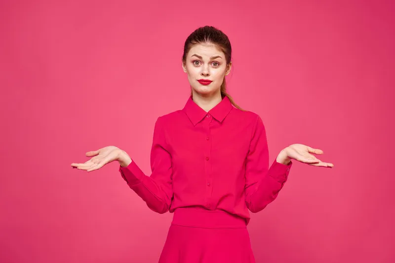 Женщина на розовом фоне в модной одежде, с ярким макияжем и причёской, модель, свободное пространство