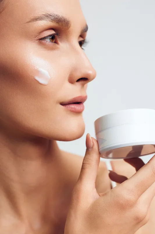 Woman, skincare, face, cream, moisturizing routine, beauty and dermatology concept, closeup portrait, soft lotion on skin, calm self care, smooth hydration