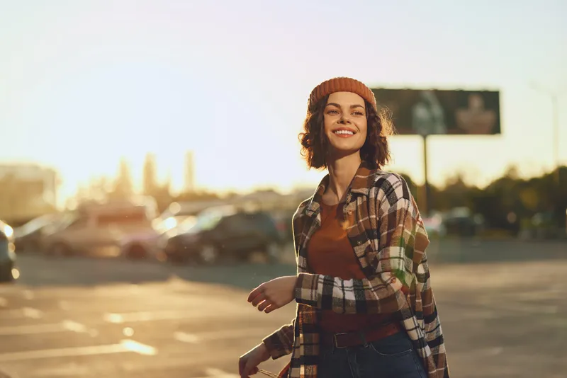 Woman smile candid golden authenticity urban lifestyle joyful portrait at sunset, candid lifestyle moment with golden hour glow, mindful living and emotional storytelling in modern city scene.