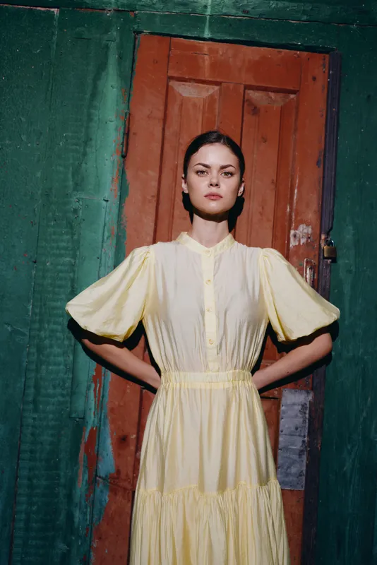 woman portrait dress vintage standing confident in doorway with authenticity and inclusivity, fashion style, natural light, strong gaze