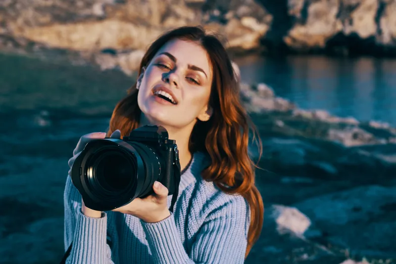 Женщина-фотограф на фоне природы, скалистые горы, приключение