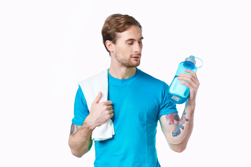 Красивый мужчина с бутылкой воды в руках, спорт, фитнес, татуировка
