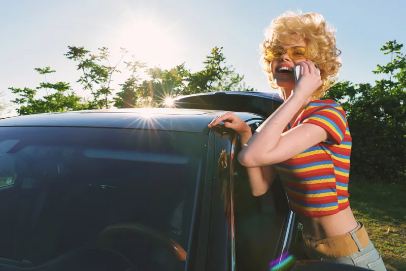Woman lifestyle retro car phone sunny outdoor smile fashion portrait with color vintage casual accessory street summer carefree posing expression daylight lens moment