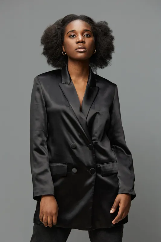 Stylish Black Model in Elegant Satin Jacket, Embracing Confidence with Natural Hair Modern Fashion Concept for Beauty and Empowerment