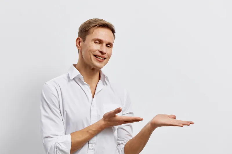 young caucasian man smiling wear white shirt present show gesture with hands isolated on white background digital nomad concept with mental health and gadgets