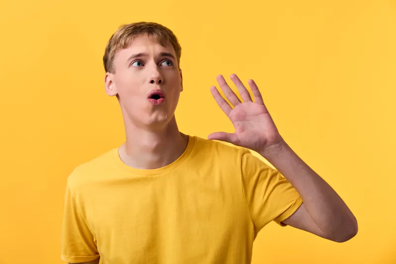 Shouting man in a yellow tee against a vivid background, capturing energy, gesture and expression for attention grabbing marketing visuals, ideal for campaign branding, product releases, and social