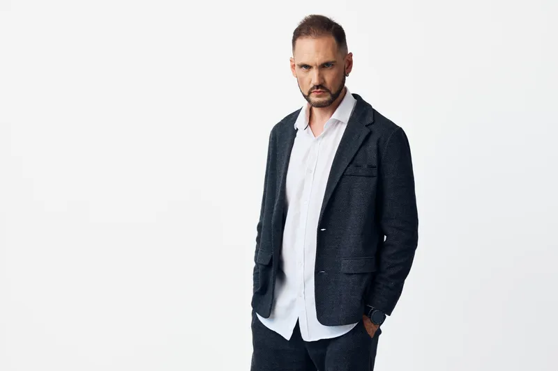 Theme portrays a male business professional with calm confidence, expressing focus and determination against an isolated colored background, highlighting poised leadership.