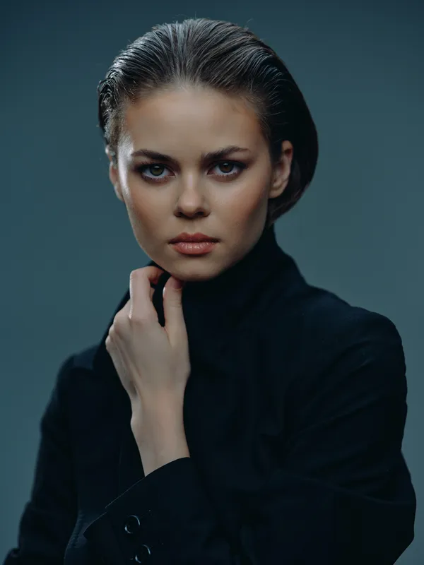 serious woman portrait with wet hair in black turtleneck against dark background