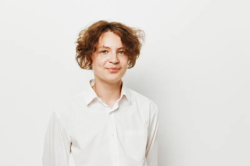 Portrait of a male business professional with a calm, confident expression, isolated on a clean colored backdrop suitable for corporate use.