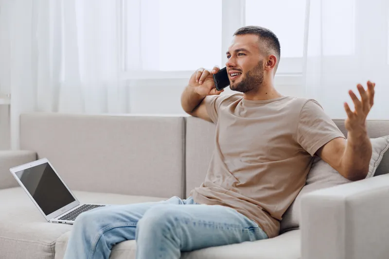 A man engaging in an honest phone conversation, showcasing authentic imperfection while navigating modern life challenges like work-life blur and emotional minimalism.