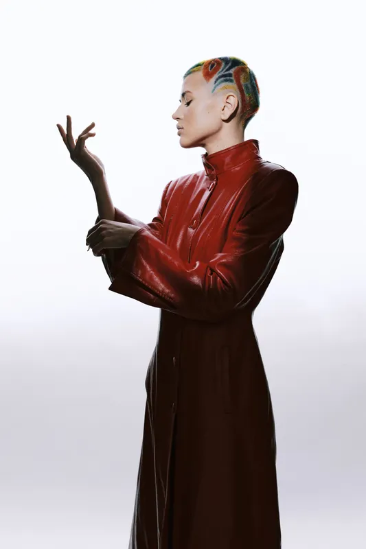 woman with artistic colorful hair wearing red leather coat posing gracefully, stylish fashion, modern, creative, unique profile portrait with minimal background