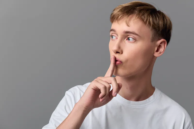 shushing, secrecy, silence, gesture, hush, finger, lips, quiet, A calm moment with a thoughtful figure signaling for silence, inviting focus and discretion in a scene of quiet communication and
