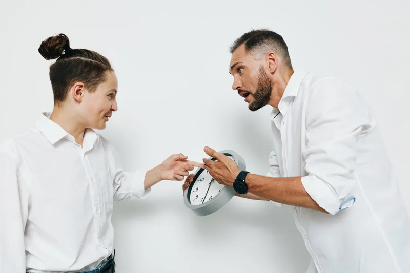 Professional business scene showing a man interacting with a colleague against a plain colored background, highlighting urgency, emotion, and determined focus.