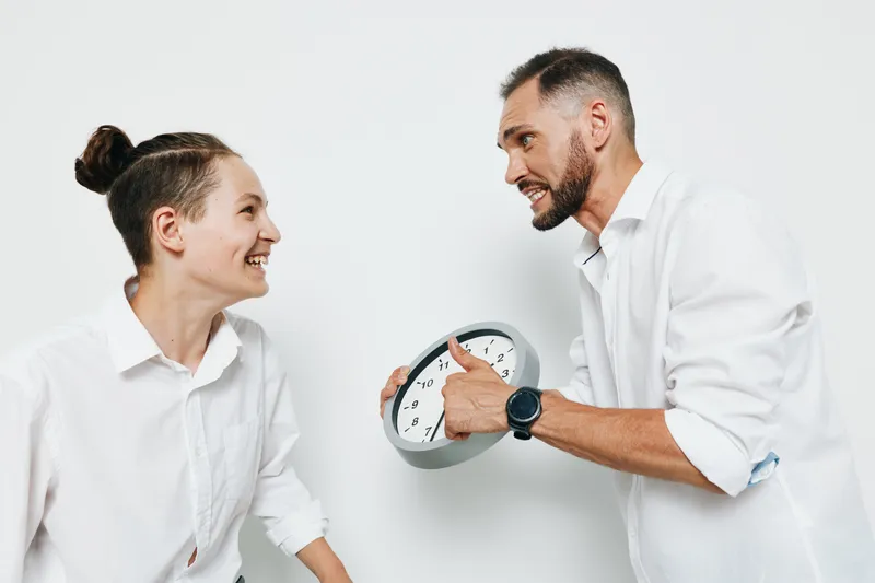 A professional man and colleague share a moment of optimism in a clean studio, isolated color background highlighting business energy, teamwork, and confident expression.