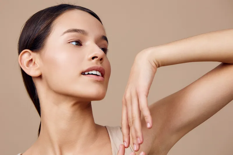 Close up portrait of a young woman with natural makeup and neutral background, showcasing healthy skin and elegance for beauty focused concepts