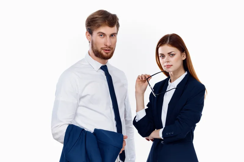Мужчина и женщина в деловых костюмах работают в офисе профессионально