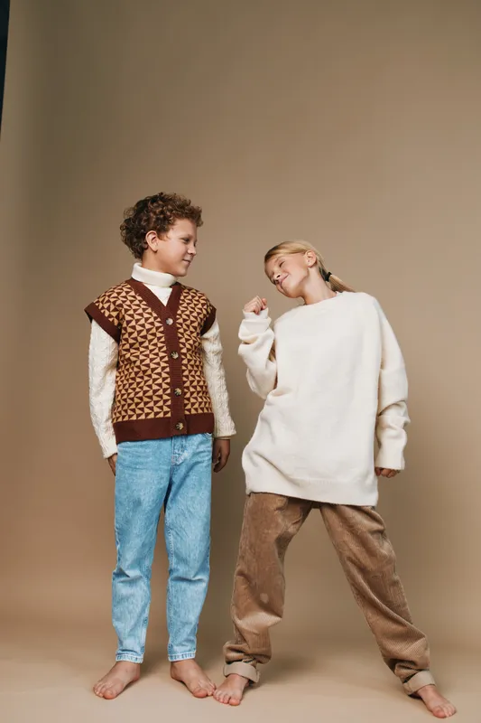 Authentic scene of playful friends in a school inspired setting, capturing lifestyle moments with cozy apparel, genuine smiles, and relaxed movement during play.