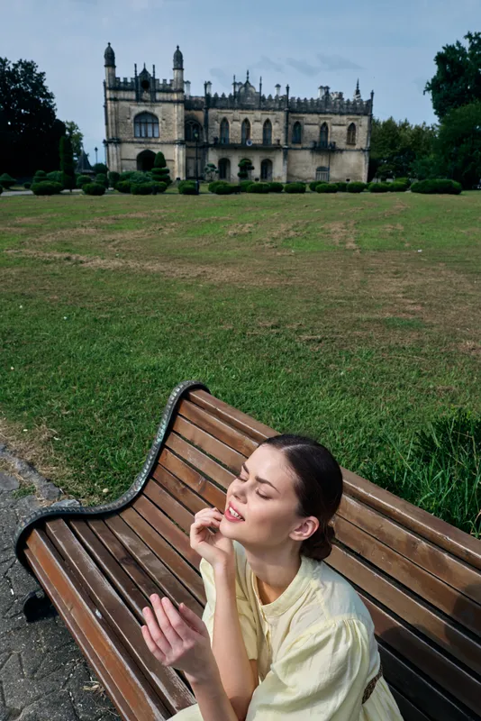 Woman bench park building sunlit portrait, authentic inclusive