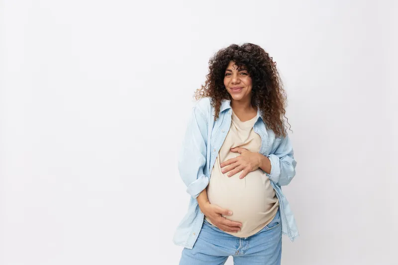 Улыбка беременной женщины и счастье материнства на белом изолированном фоне