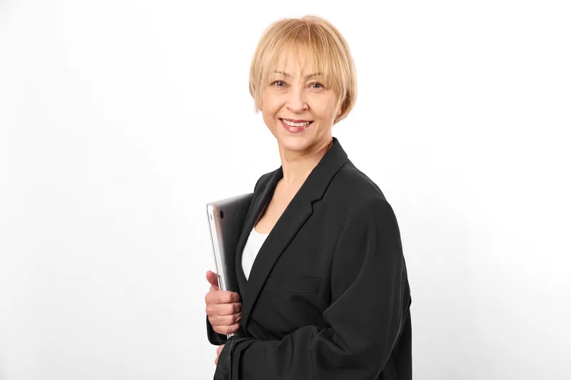 Woman in business suit, smile holding folder, office portrait against white background, confident professional mood, soft studio lighting for career success.
