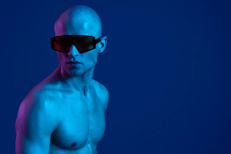 Portrait of a man wearing sunglasses, showcasing a bold and vibrant blue color scheme. The image exudes a modern, artistic vibe perfect for contemporary projects.