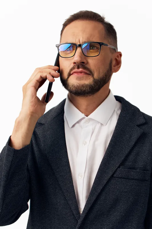 A professional man on a call, showing confidence and focus, captured on a colored isolated background. The scene highlights business mood, determination, and active engagement in strategic dialogue.