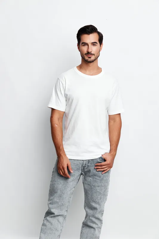 Full body confident young man wearing casual clothes standing on plain solid light background with a relaxed expression. People lifestyle concept.