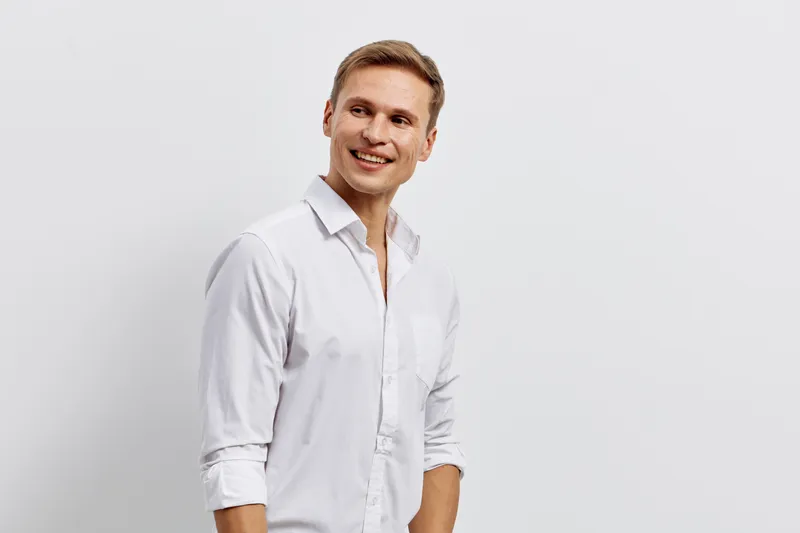 Smiling young caucasian man in white shirt look side standing isolated on white background digital nomad remote work concept