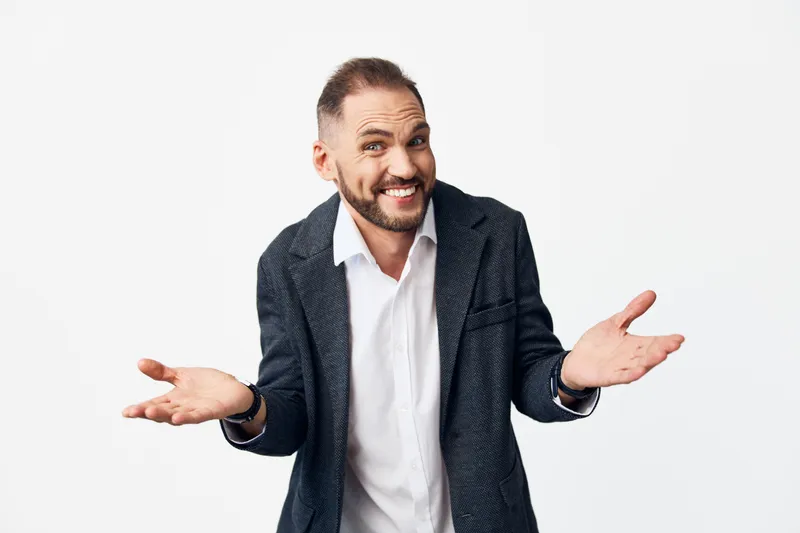 A professional businessman with a confident smile stands against an isolated colored backdrop, projecting approachability and leadership suitable for corporate communications and client engagement.