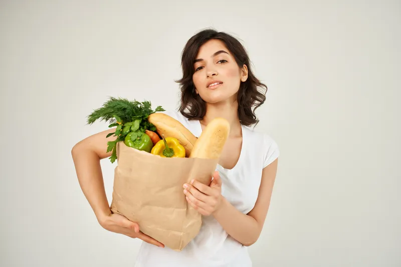 Женщина с пакетом продуктов в супермаркете, служба доставки