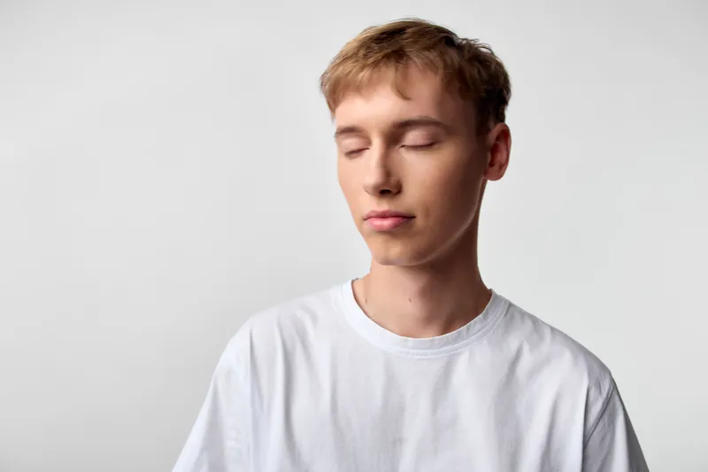 Serene, calm, meditation, youth, white t shirt, stillness, face, minimal, studio, soft, light, quiet, balance, focus, simple, mood, tranquil, peaceful, relaxation, serenity, expression, clean,