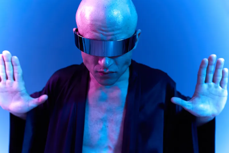Bold man in futuristic attire, conveying a sense of confidence and mystery, with a vibrant blue and purple background enhancing the atmosphere.