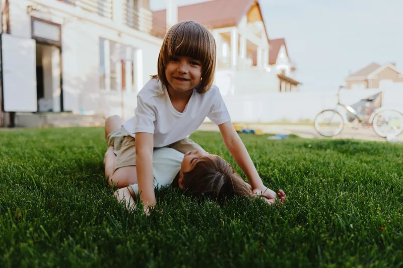 Happy children playing on green grass, enjoying a sunny day. Their laughter fills the air as they engage in fun activities outdoors, creating wonderful memories together.