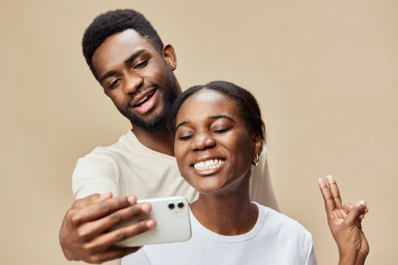 Cheerful young couple taking a selfie together, showcasing happiness and love during their quality time Perfect for relationship themes and social media content