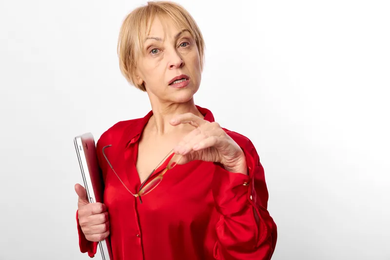 Woman thermometer fever illness sick health flu concerned, older female holds thermometer and points, showing symptoms of flu and illness against white background.