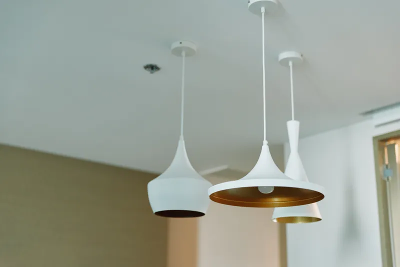 Pendant lights interior lighting hanging lamps ceiling modern decor design over a room with white fixtures and copper interior, warm glow for a minimal contemporary living space