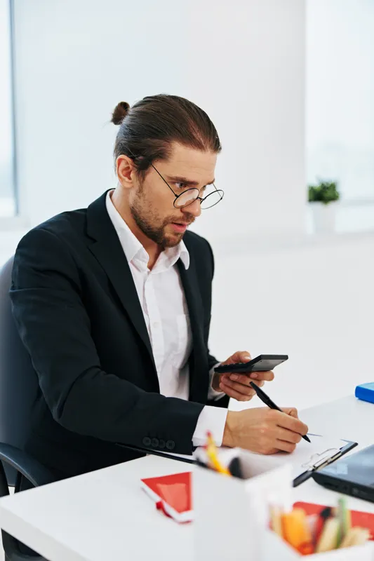 Менеджер работает в офисе перед ноутбуком