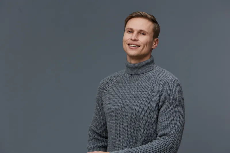 Smiling man young adult casual clothing portrait cheerful happy confident isolated on plain gray background. People lifestyle concept