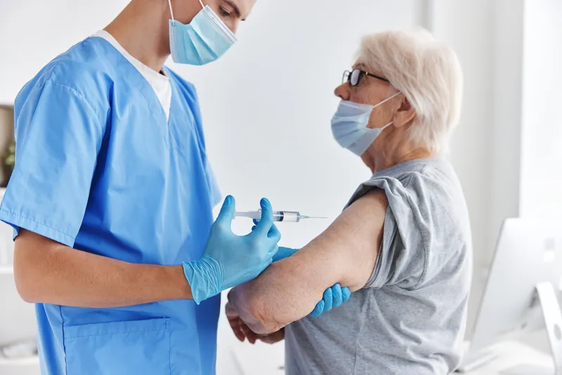 Пожилая женщина с паспортом вакцинации от COVID-19, медицинское обслуживание