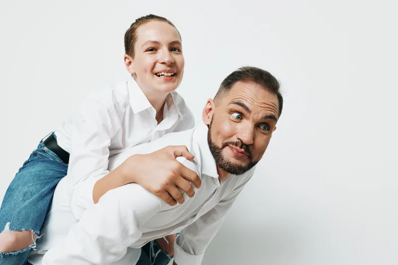 Professional man with a warm smile on an isolated white background, exuding confidence and focus, suitable for business themes of leadership, collaboration, and professional emotion.