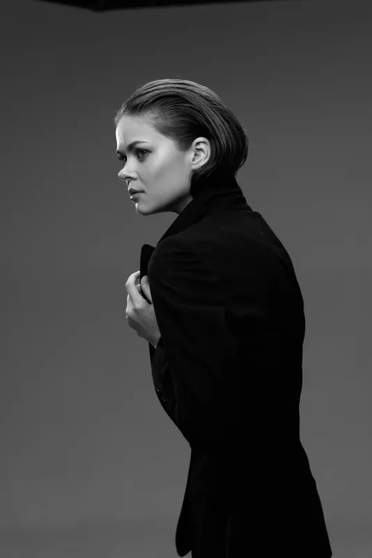 Black and white portrait of a young woman in a dark jacket with a serious expression
