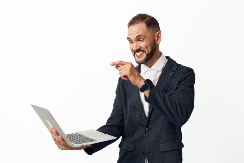 A corporate professional man with a laptop radiates confidence and energy against a bright isolated colored background, conveying optimism, focus, and engaging business charisma.