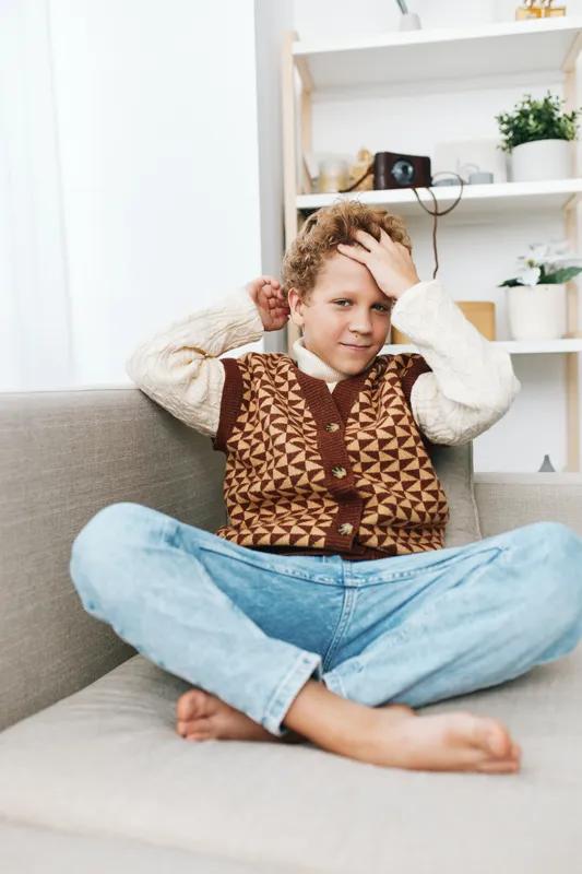 An authentic candid scene of a child at home, capturing a playful, school inspired lifestyle moment. Cozy, relaxed, and true to everyday life.