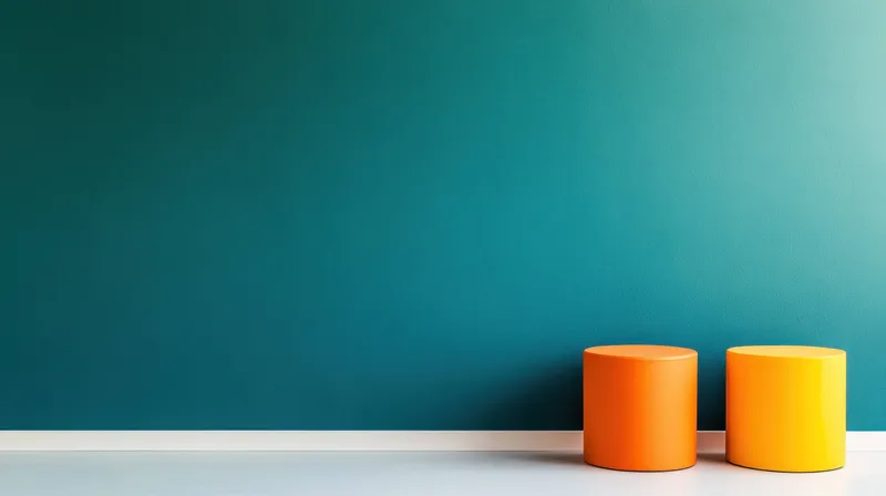 Стильный современный интерьер с двумя оранжевыми круглыми табуретами на фоне насыщенной бирюзовой стены, идеально подходящий для современного дизайна и цветовых решений