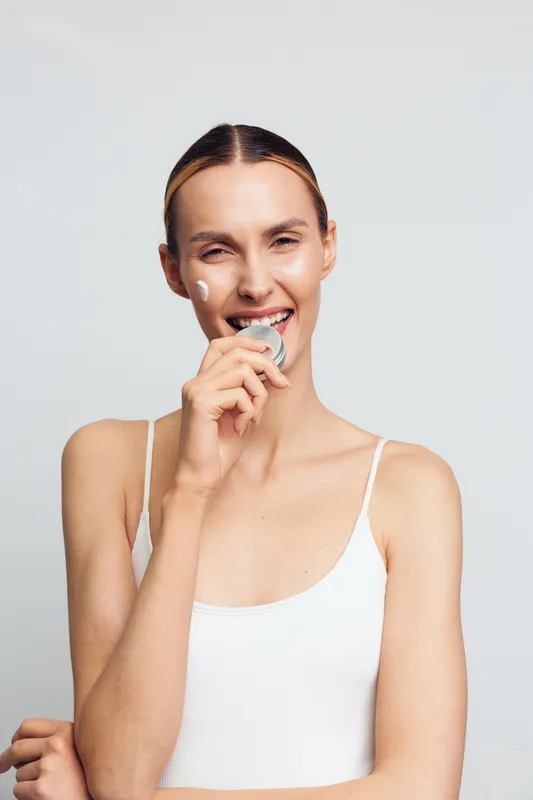 Young woman with smile, dental care, clean teeth and oral hygiene, beauty portrait on white background, relaxed pose, natural light, close up, calm expression